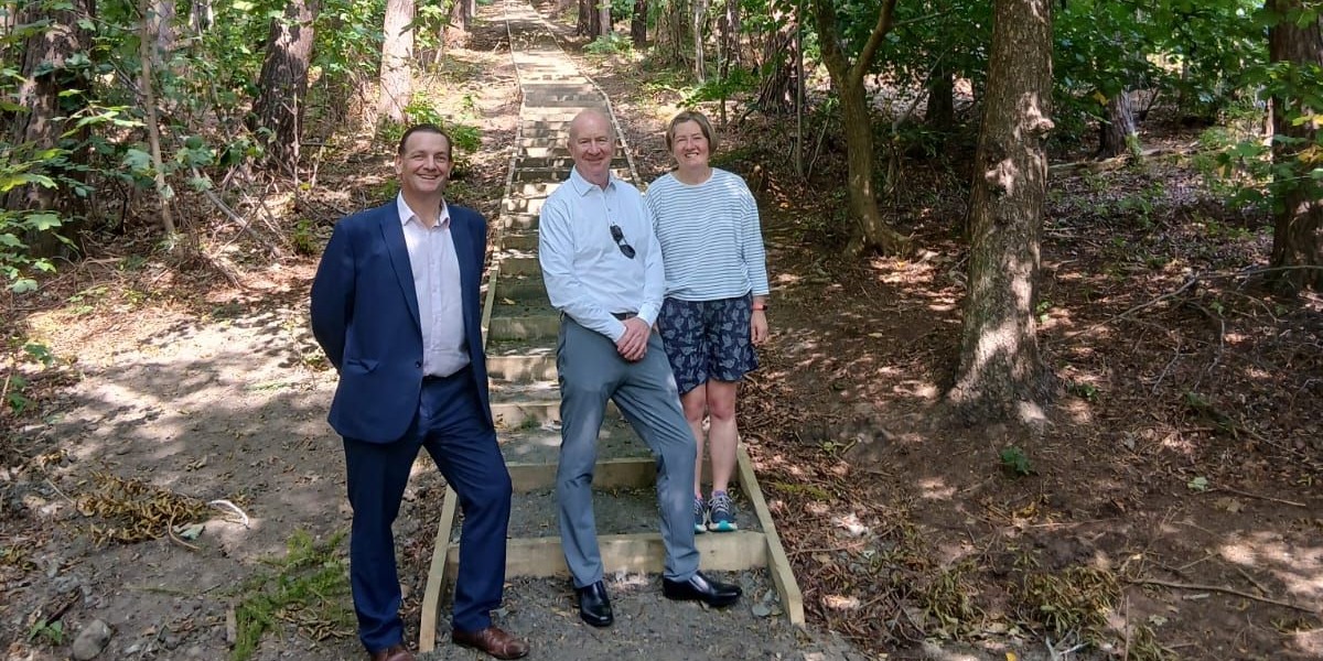 📷 Robert Hammond (Falkirk Council), Councillor Paul Garner and Nicola Duenas (Green Action Trust) at the wider and resurfaced flight of 110 steps which ascend from the Millhall Burn to the top of the woods. 