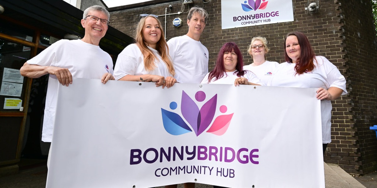 📷 Six of the eight members of Bonnybridge Community Hub’s committee with their new logo.