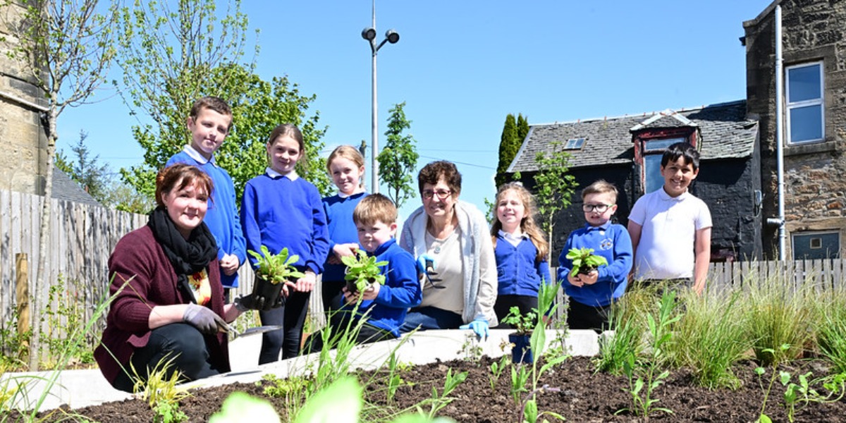 📷 Pupils from Slamannan Primary School help members of the local gardening club plant flowers in the village's new pocket park. 